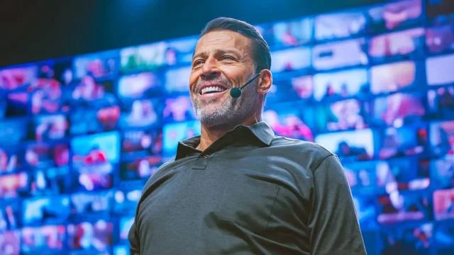 Tony Robbins speaking on stage, from the company profile
